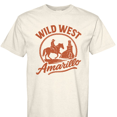 White shirt featuring a orange graphic of a cowboy riding a horse towards the Palo Duro Canyon Lighthouse and text reading 'Wild West Amarillo'